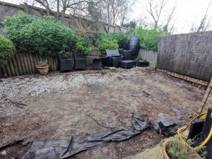 Back garden with the decking removed, leaving bare ground