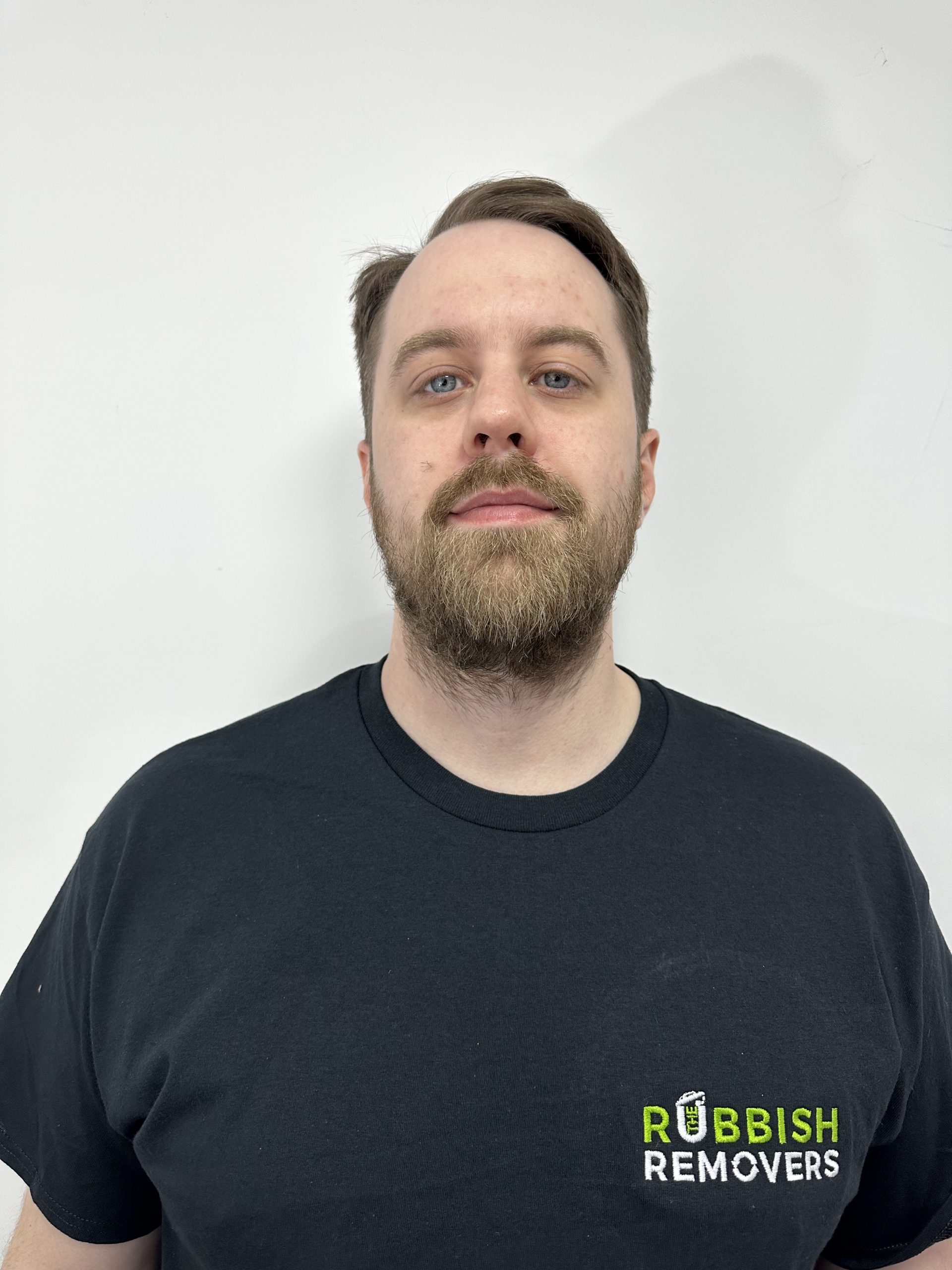 Headshot of a bearded team member in a black Rubbish Removers T-shirt