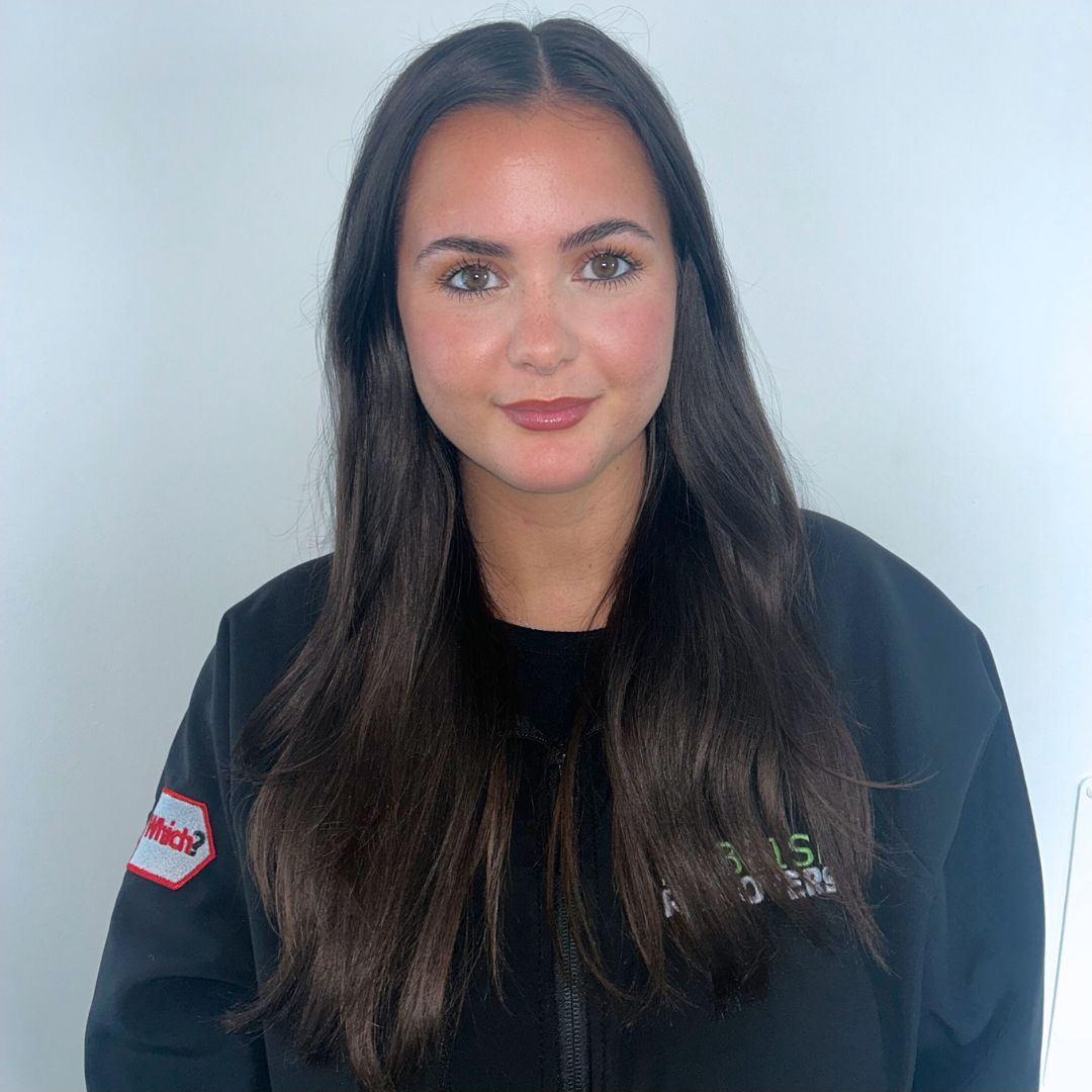 Headshot of a team member with long dark hair in a black Rubbish Removers hoodie