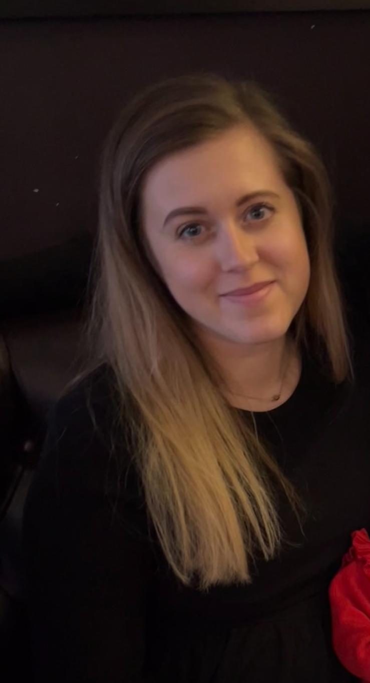 Headshot of a smiling team member with long fair hair