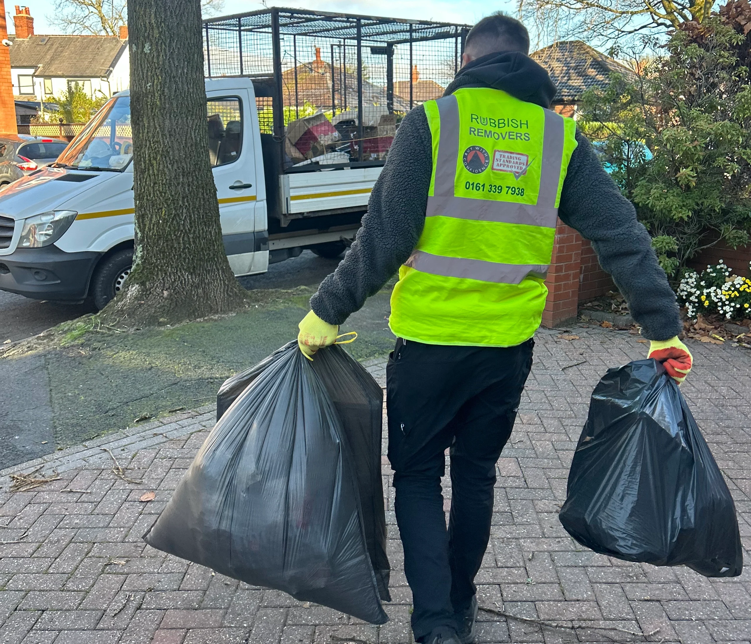 The Rubbish Removers team member removing bagged waste from a home