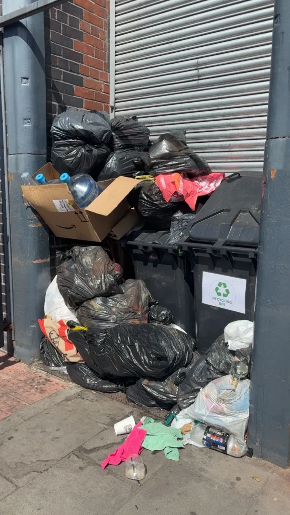 Image showing overflowing bins at a commercial waste collection in Bury.