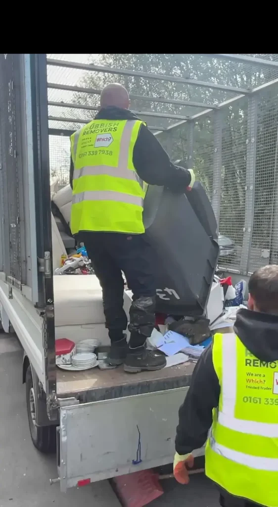 Image showing 2 team members loading a sofa onto the van.