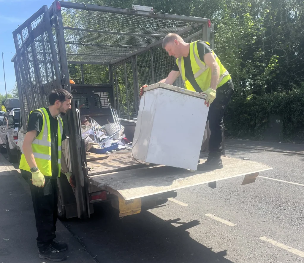 Image showing a member of staff loading the vehicle from a Chroley fridge removal we completed.