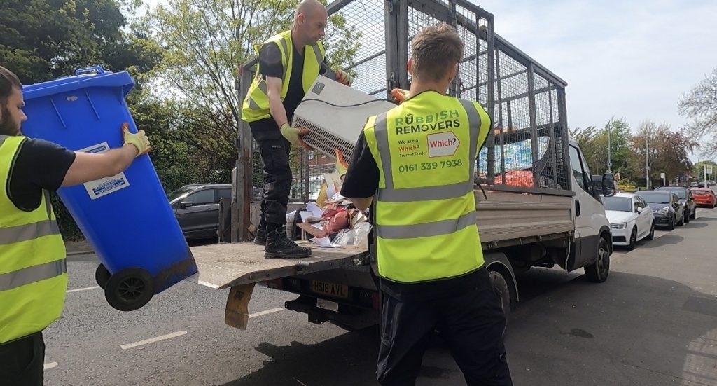 Uniformed crew loading household items onto the van