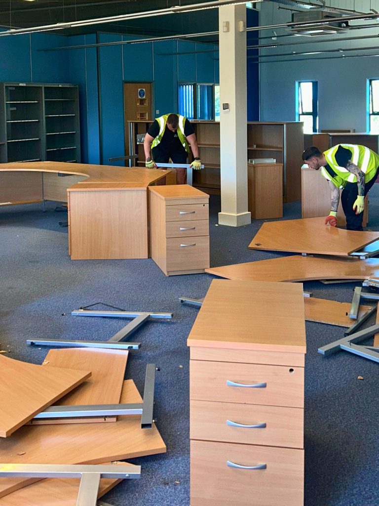 Image showing staff dismantling desks at a chorley commercial waste collection we completed.