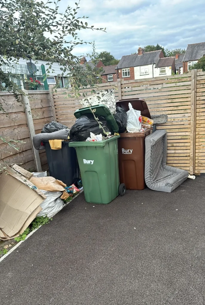 bins storage area overflowing with waste.