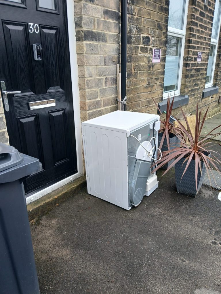 Image of a washer waiting to be collected from a property.