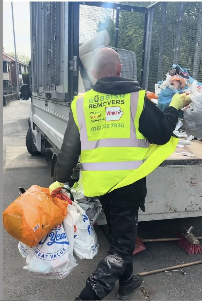 Image of staff loading vehicle with rubbish ready for disposl.