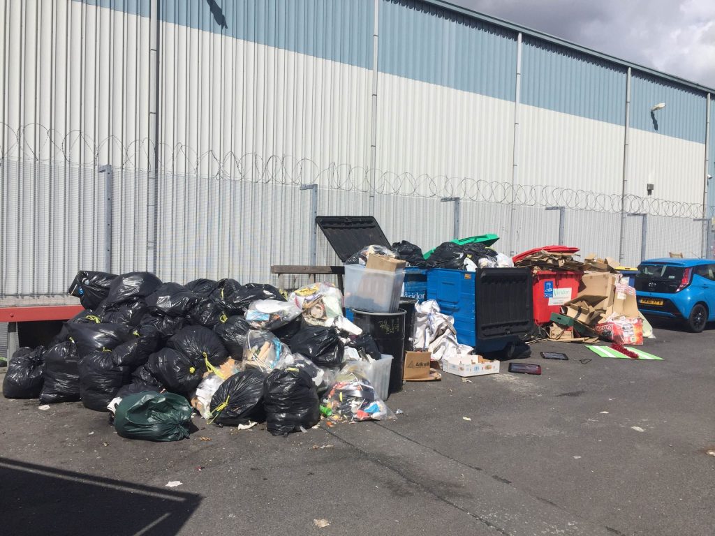 Image showing bin waste that needs clearing from an industrial property.