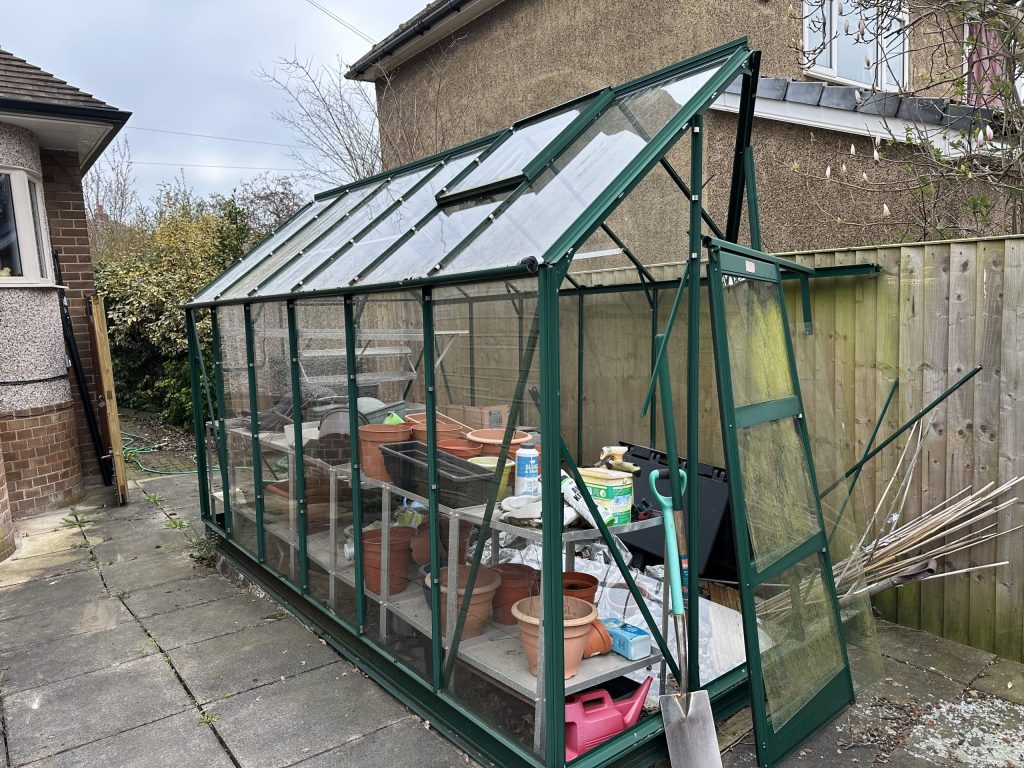 Image of greenhouse and contents before we cleared it away.