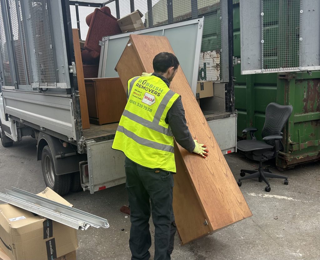 Unwanted large office furniture being loaded onto the van