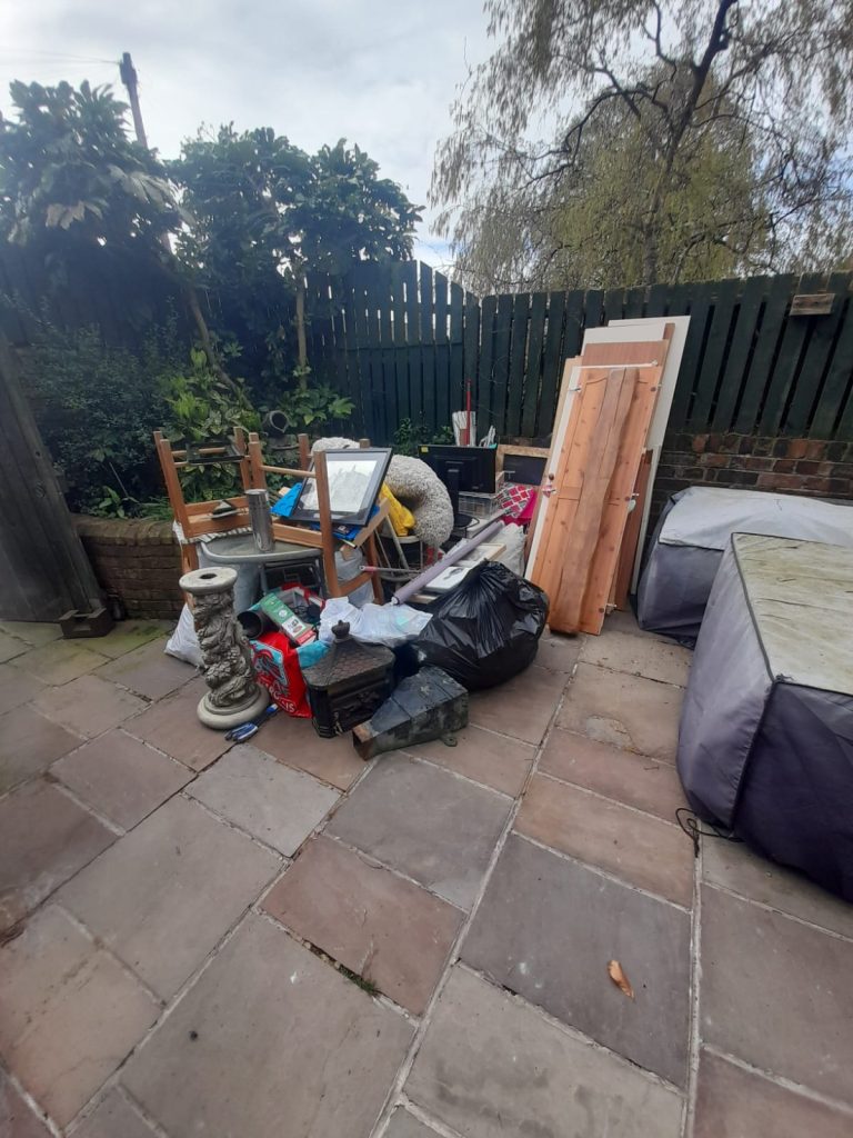 Image showing general household junk in a garden ready for us to clear.