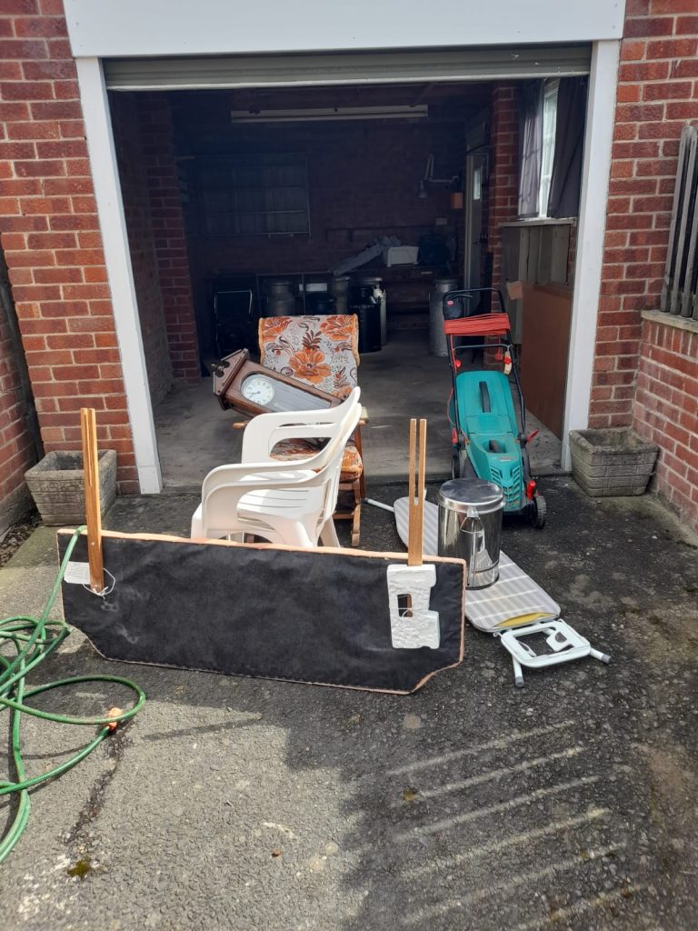 Image of rubbish in a garage that needs clearing.
