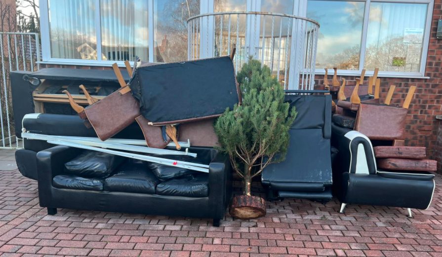 Large bulky sofas brought out of the house and ready to be loaded.