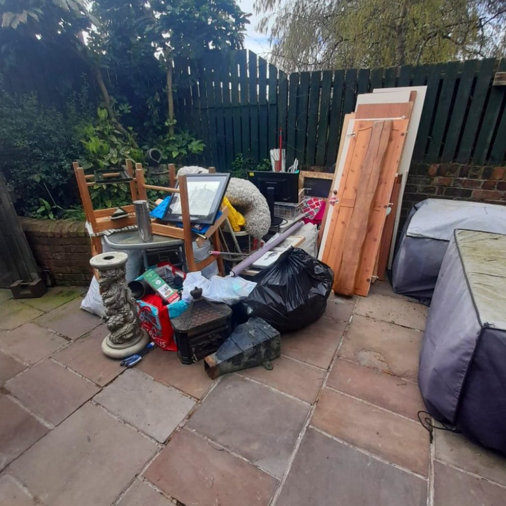 A picture of a garden full of general waste that the Rubbish Removers cleared.