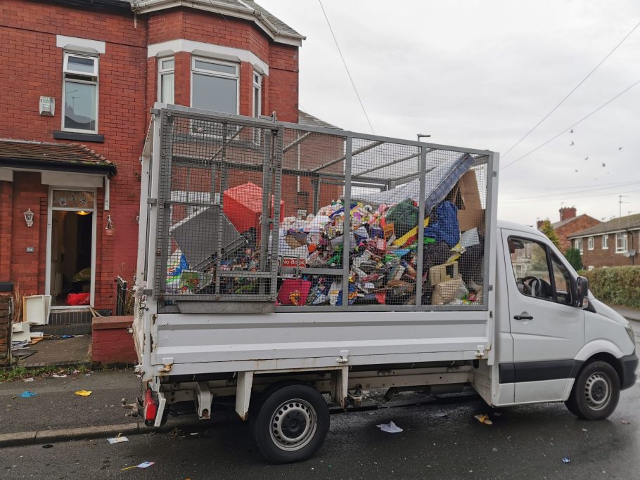 Vehicle outside a property full of items and ready to be disposed of