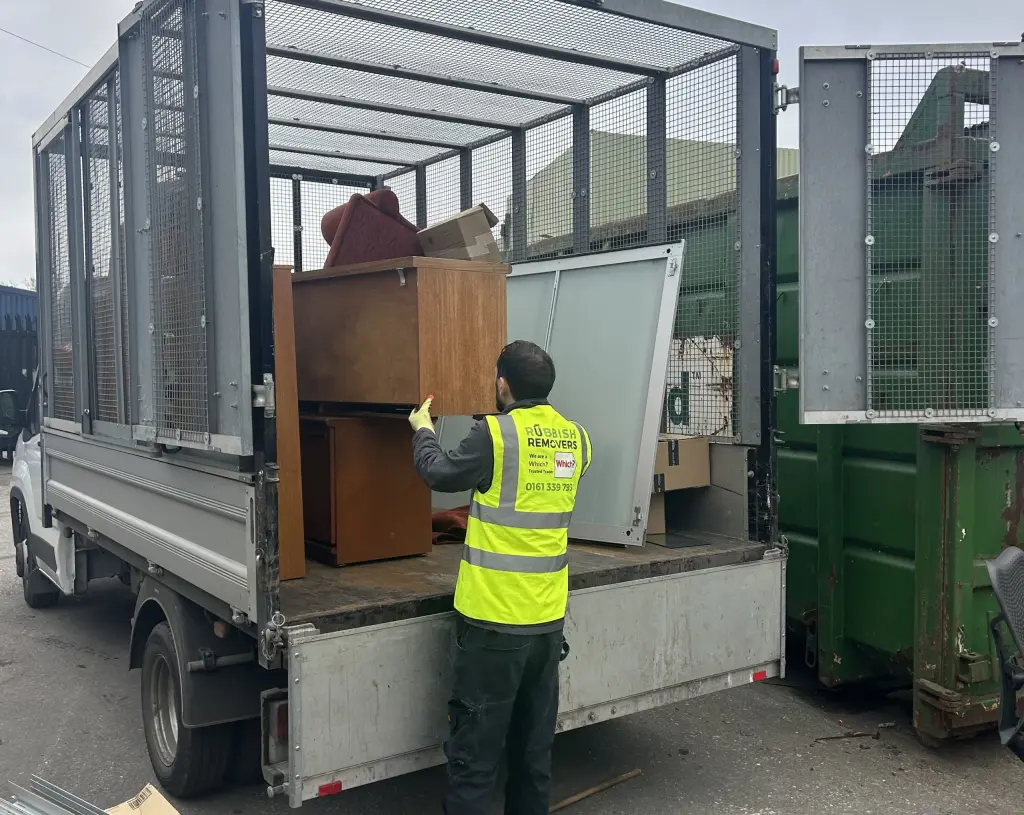 Large office furniture being loaded onto the van by a trusted team member