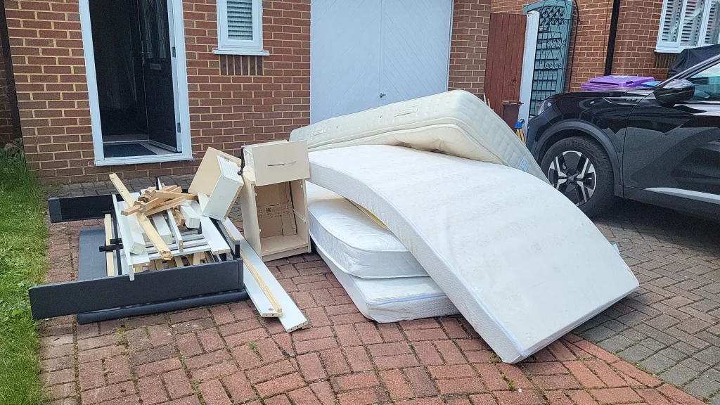 Image showing mattresses and bed frame ready to be collected from a property.