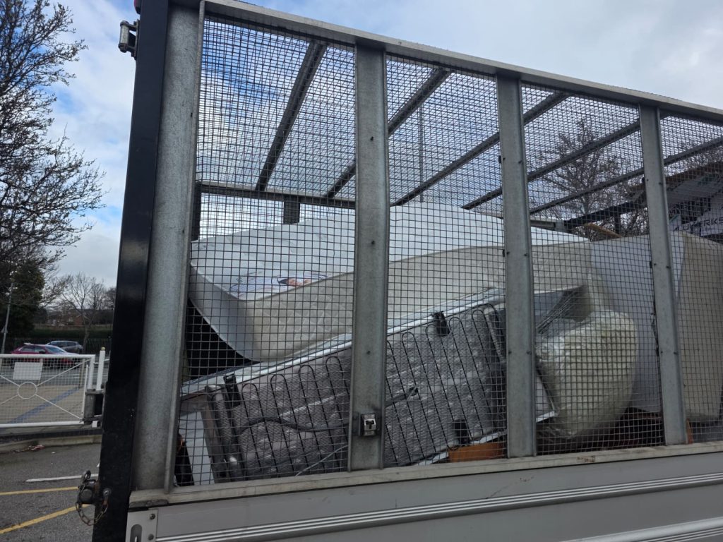 Mattresses and bed frames on our vehicle ready for disposal.