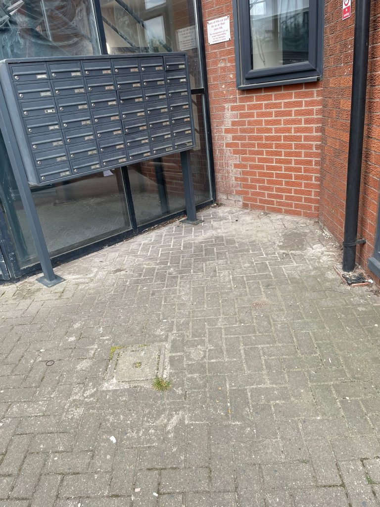 Cleared and tidy front entrance at Castle Court after the tower block bin clearance in Salford