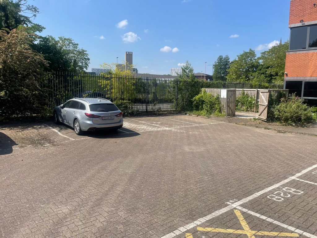 Cleared and tidy car park at Castle Court after the tower block bin clearance in Salford