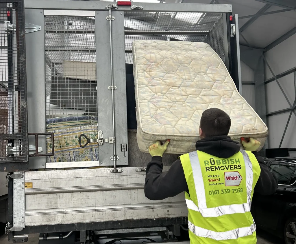 Staf loading mattress onto vehicle