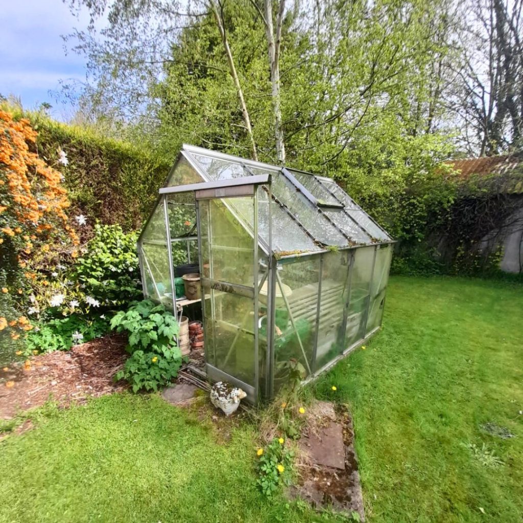 A picture of a large greenhouse full of general waste that the Rubbish Removers dismantled and removed.