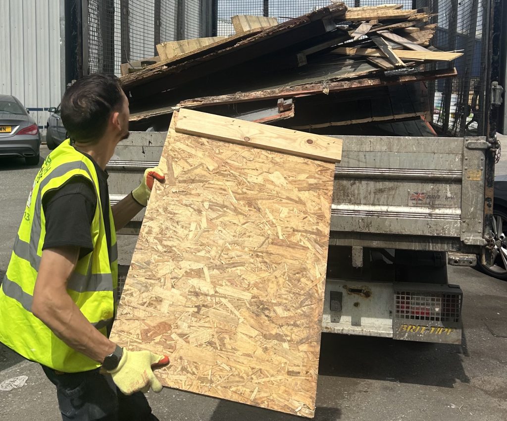 Unwanted wood waste being loaded onto the van