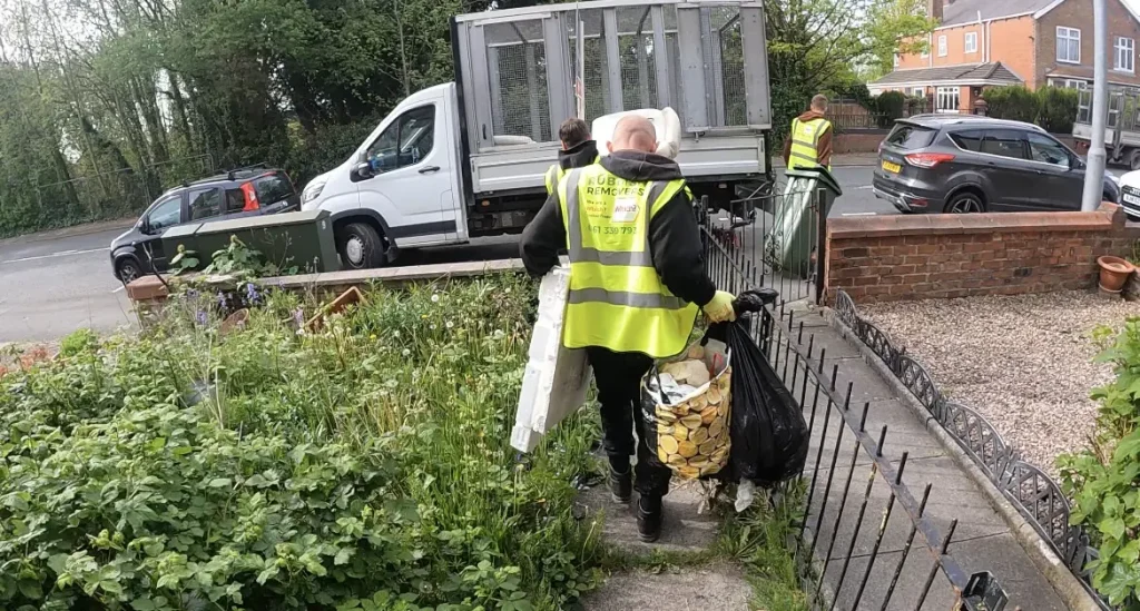 Staff members collecting general waste from a property in Rotherham.