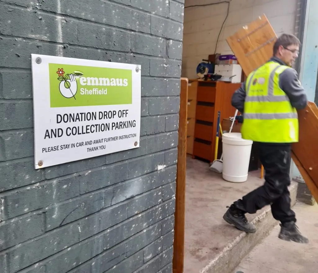 Staff donating furniture to a charity.