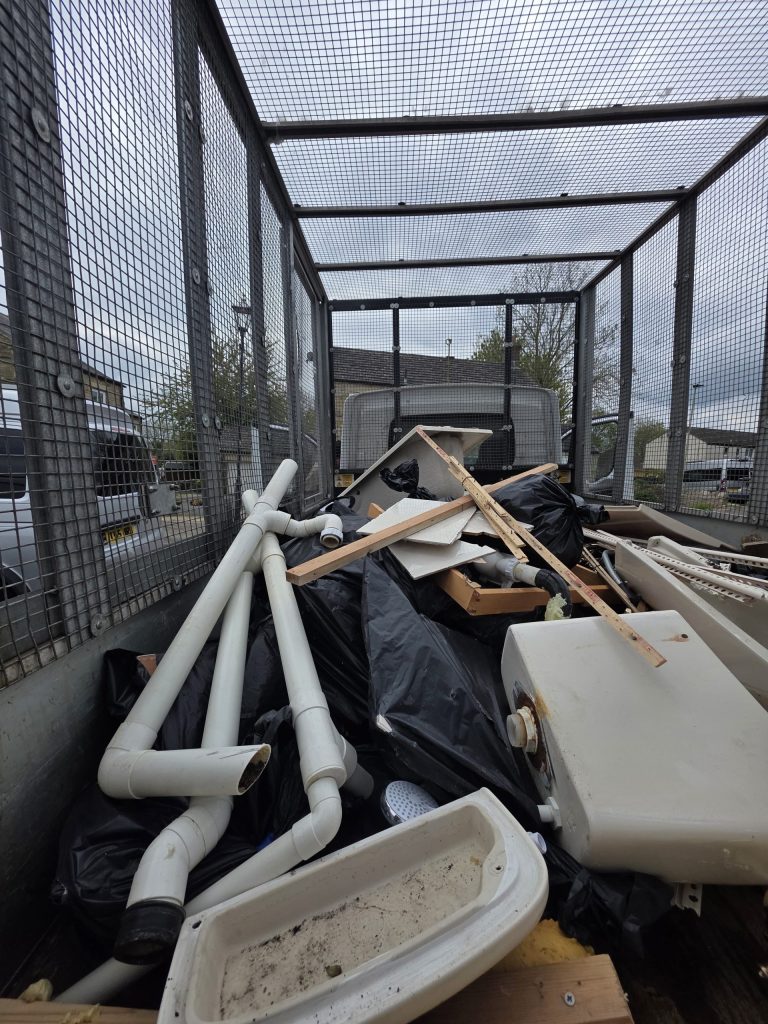 Trade waste loaded into a caged tipper in Hale Barns.