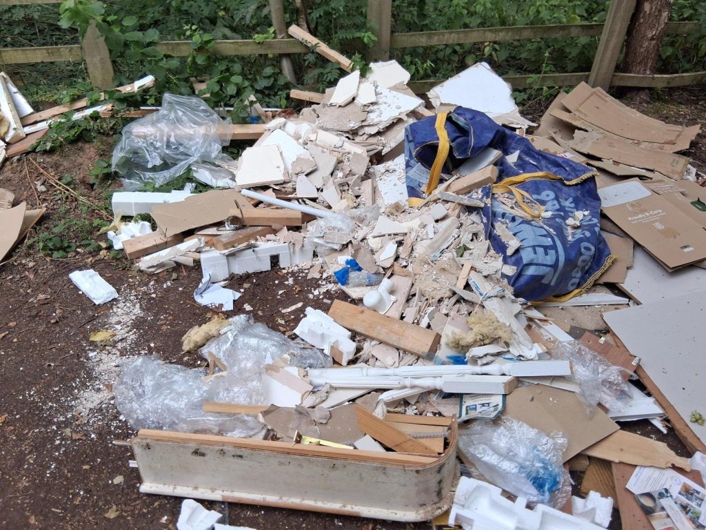 Fly-tipping clearance in Selby showing builders' waste dumped across a public track.