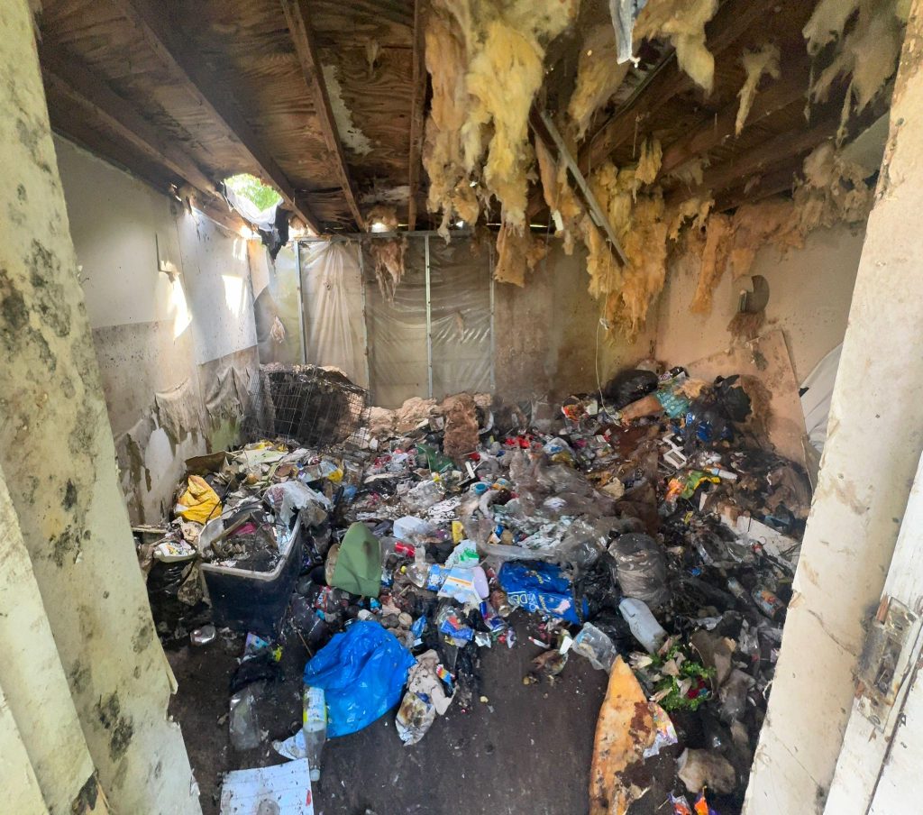 Outbuilding emptied during a solicitor-managed garden clearance in Heywood.