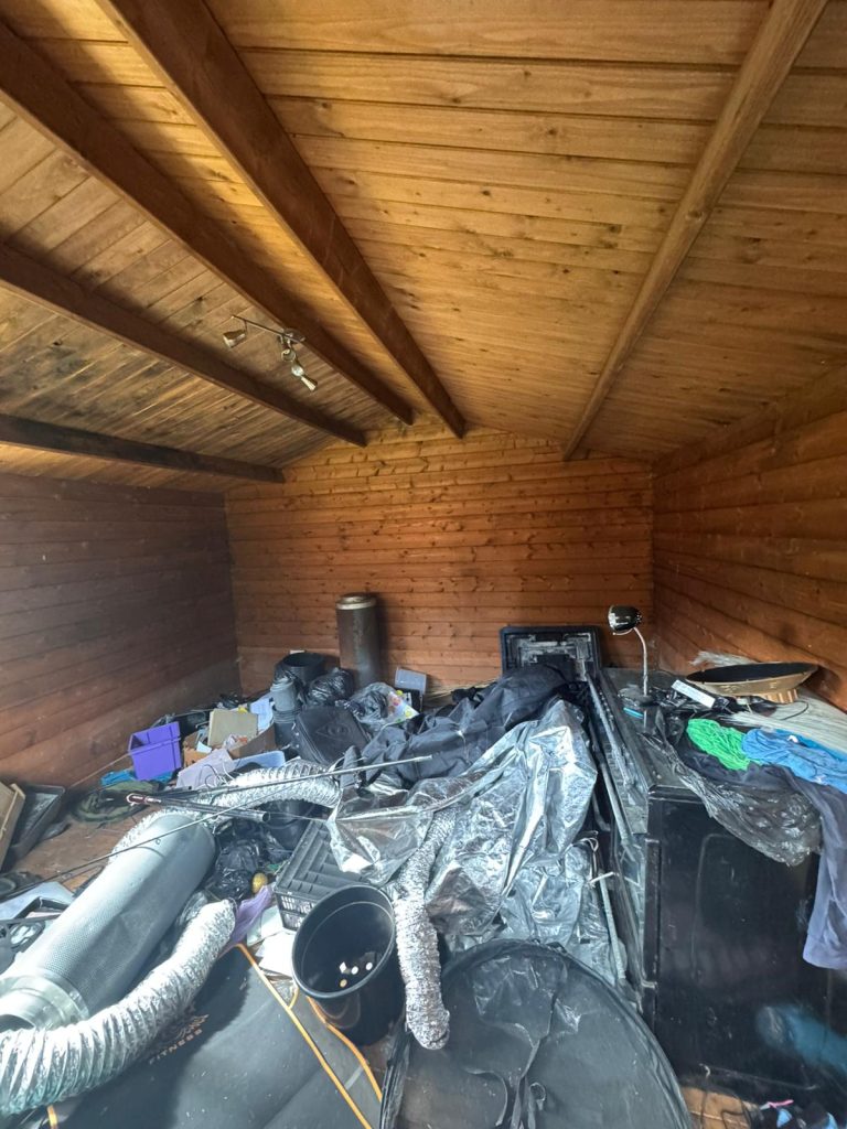 Timber lodge containing cannabis cultivation equipment before removal.