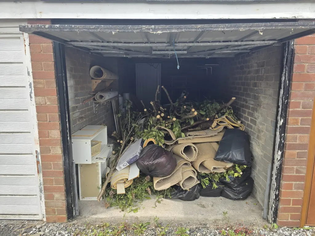 Garage clearance in Ashton-under-Lyne before waste removal.